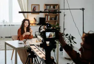 influencer in front of camera making a video for a blog that explores examples of viral marketing