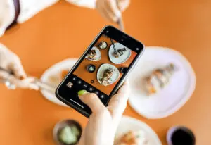 photo of phone taking picture of curated plate of food for a blog about how to rebrand your instagram