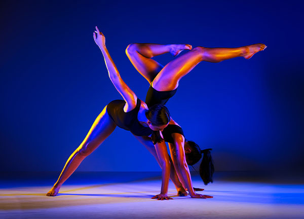 Two dancers posing with purple lighting Two dancers posing with purple lighting