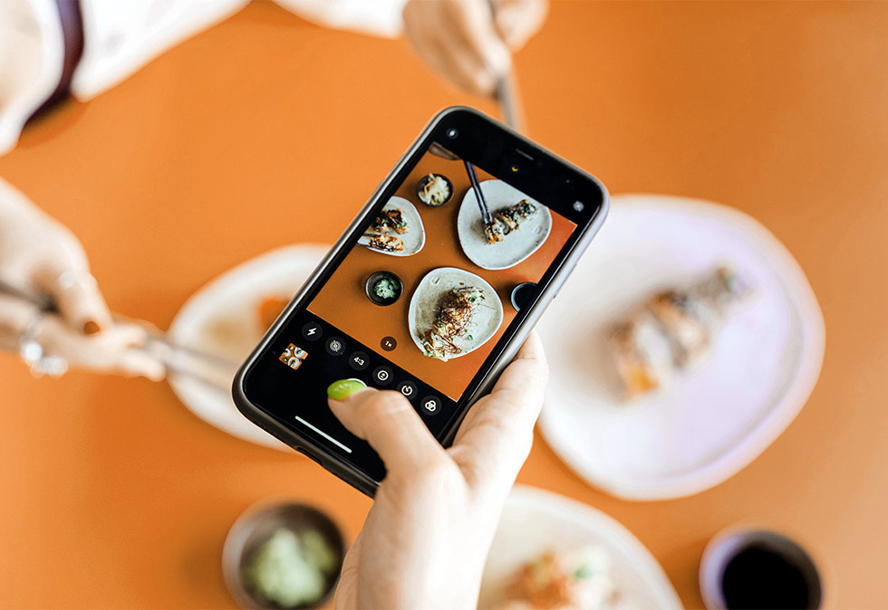 savy-blog-062525 photo of phone taking picture of curated plate of food for a blog about how to rebrand your instagram