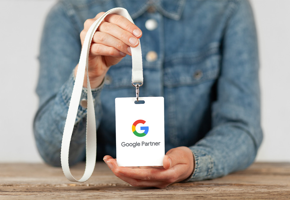 Savy-Oct-Blog-1 Person holding google partner lanyard for a blog about Why You Need a Google Partner SEO Agency