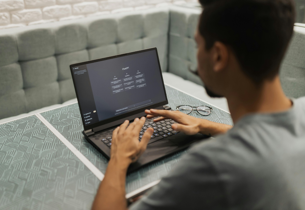 Savy-July-Blog-2 Man sitting at laptop for a blog about generative engine optimization and How to Get Your Brand Cited by ChatGPT and Google AI Overviews