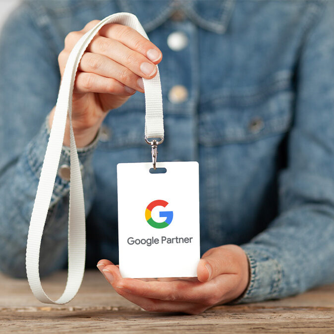 Person holding google partner lanyard for a blog about Why You Need a Google Partner SEO Agency, answer engine optimization agency